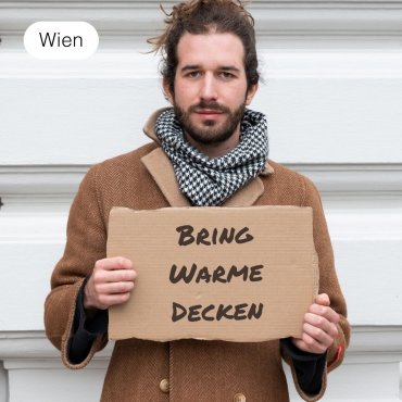 Bring eine warme Wolldecke für obdachlose Menschen